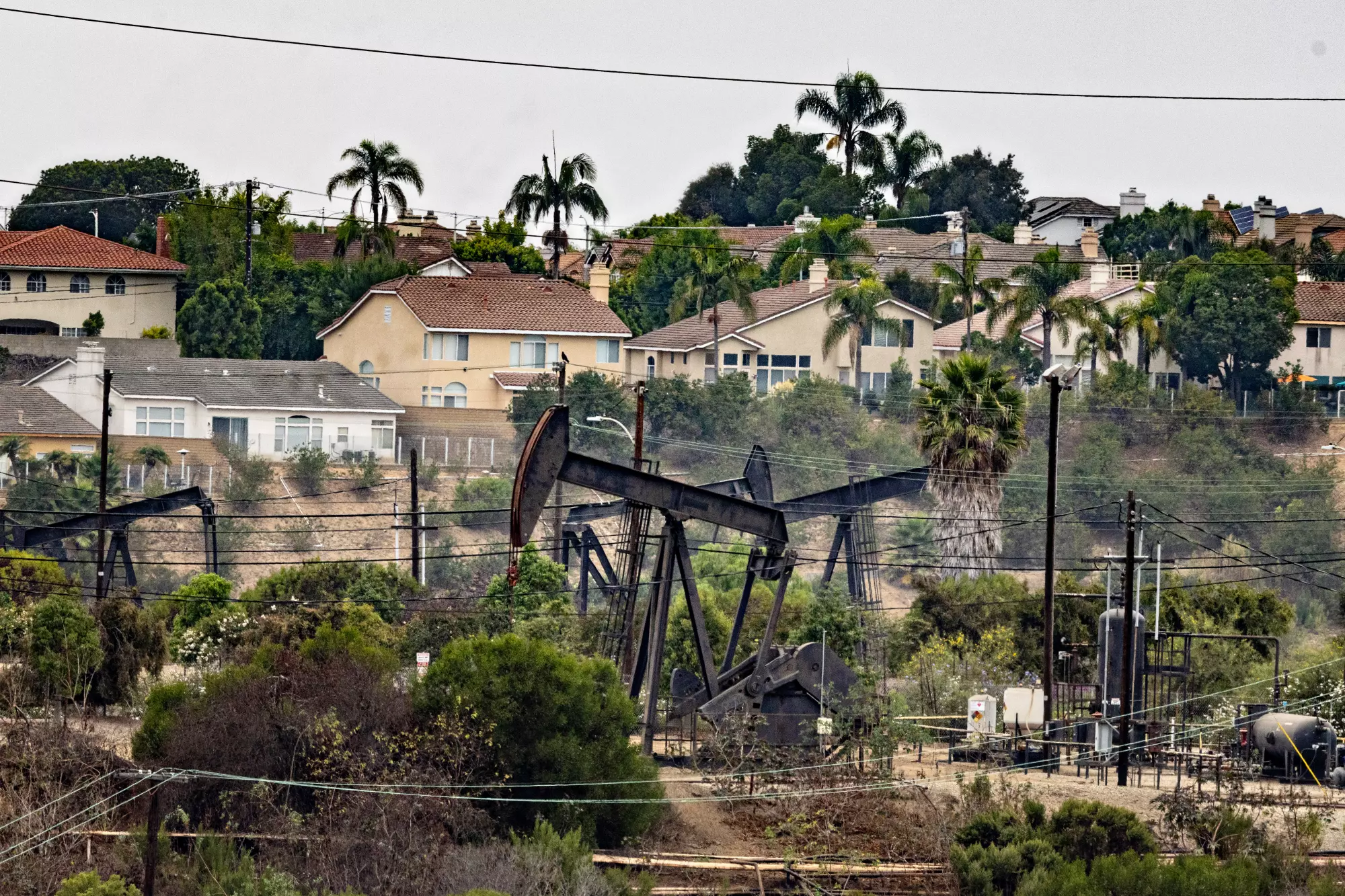 Pumpjacks in the Inglewood Oil Field operate in close proximity to homes in September 2024. (Jason Armond / Los Angeles Times)